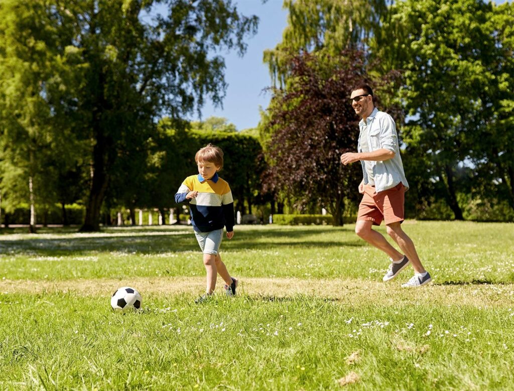 Father and son playing football
